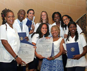 First class of US graduates of ELAM showing their degrees